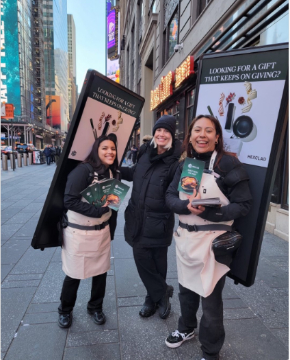 WanderVert street team wearing Vertbag LCD displays and handing out leaflets on a city street