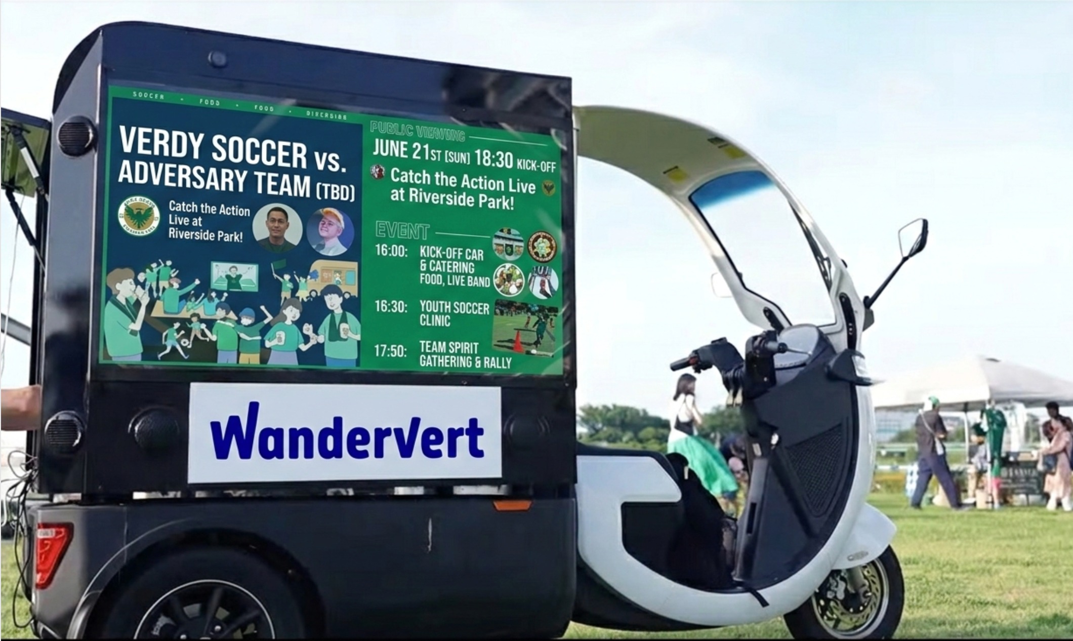 WanderVert electric trike with LED display at an outdoor event